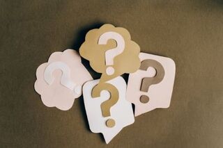 Four questions marks in shades of pink, brown, and tan.